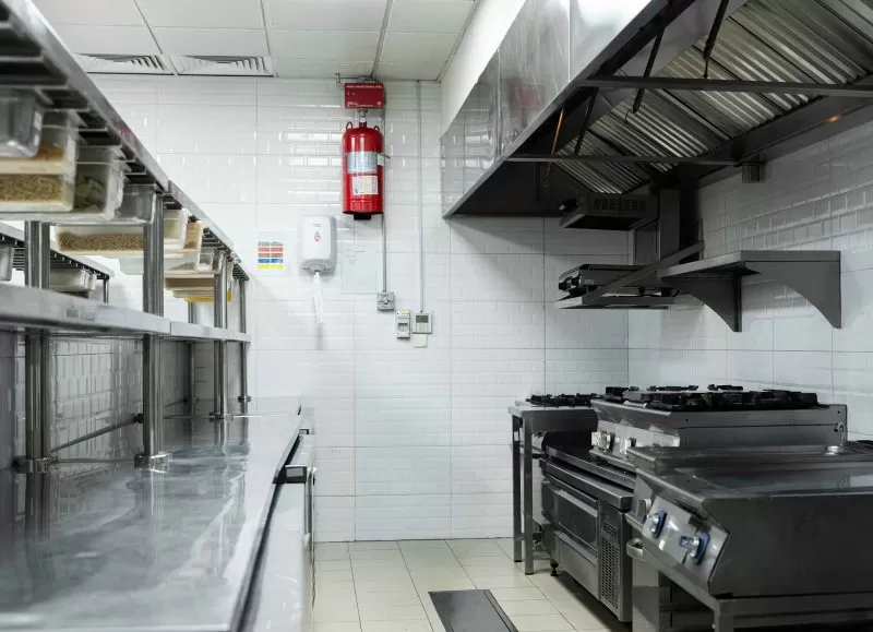 Hot line with ranges under the extraction hood in the Plum kitchen