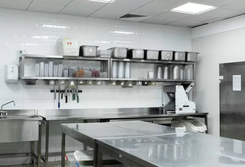 Prep station with knives and stainless shelves in the Plum kitchen